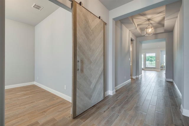 14312 Home Trl, Fort Worth, TX 76262 - hallway with wood finished floors, baseboards, and a barn door