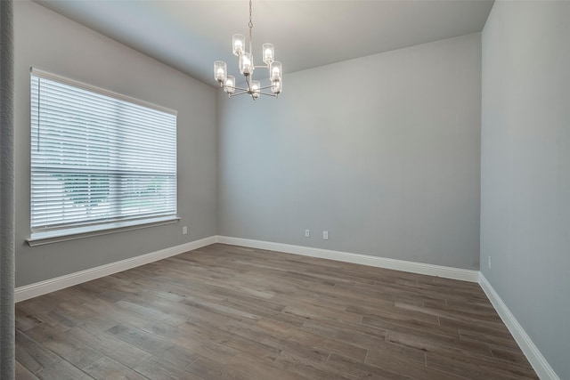 14312 Home Trl, Fort Worth, TX 76262 - spare room featuring wood finished floors, a chandelier, and baseboards