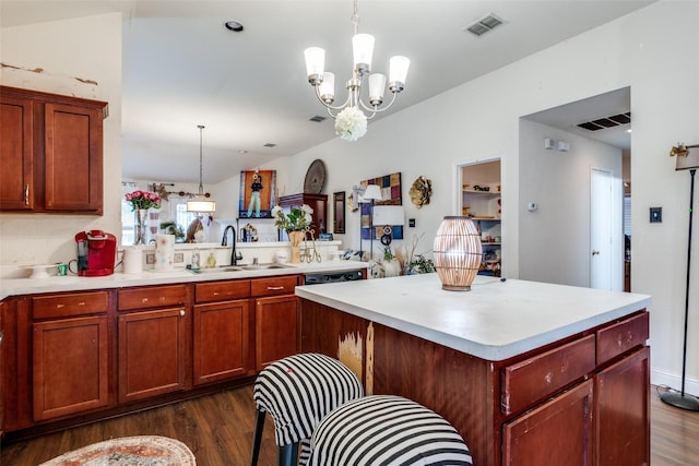 1727 Blacksmith Dr, Dallas, TX 75253 - kitchen with a sink, dark wood finished floors, light countertops, a chandelier, and hanging light fixtures