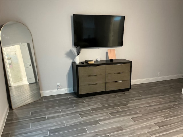 bedroom with wood tiled floors and baseboards