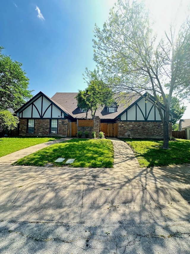 tudor home with stone siding and stucco siding