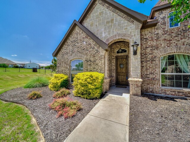 129 Spring Meadow Dr, Springtown, TX 76082 - view of exterior entry with brick siding