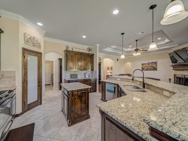 129 Spring Meadow Dr, Springtown, TX 76082 - kitchen featuring arched walkways, a sink, appliances with stainless steel finishes, ornamental molding, and a large island