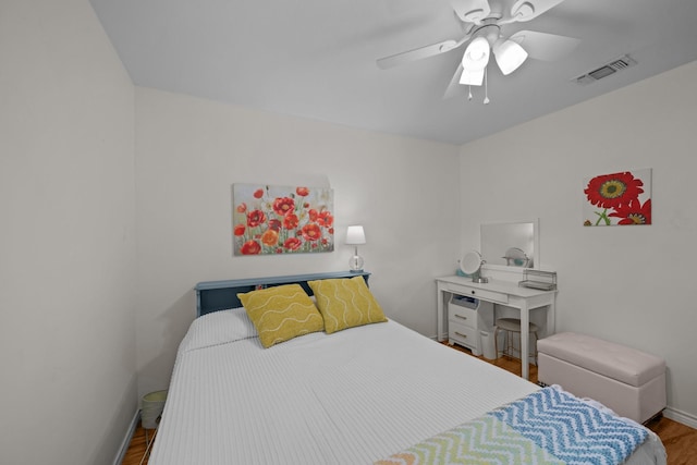 bedroom featuring wood finished floors, baseboards, and ceiling fan