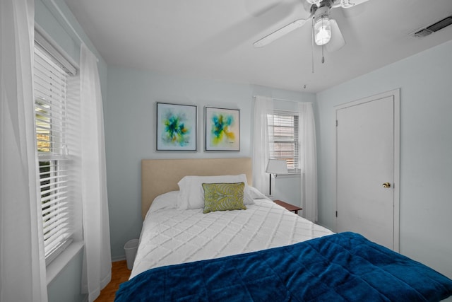 bedroom featuring a ceiling fan and wood finished floors