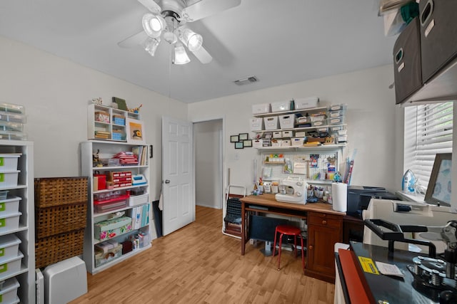office area with a ceiling fan and light wood-style flooring