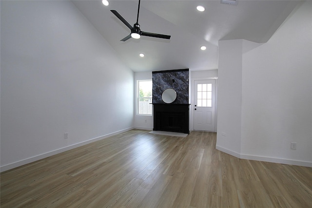 13308 Kempwood Ln, Dallas, TX 75253 - entryway featuring a ceiling fan, a high end fireplace, light wood-style floors, baseboards, and high vaulted ceiling