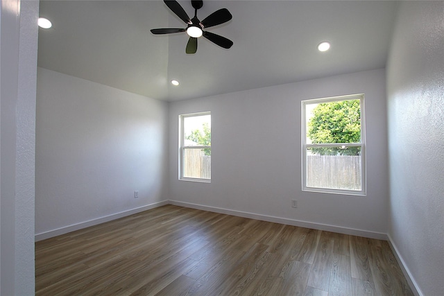 13308 Kempwood Ln, Dallas, TX 75253 - unfurnished room with healthy amount of natural light, wood finished floors, vaulted ceiling, ceiling fan, and baseboards