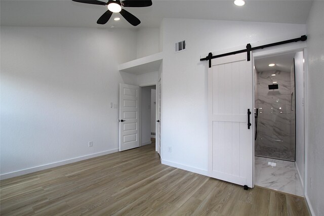 13308 Kempwood Ln, Dallas, TX 75253 - unfurnished bedroom with a barn door, light wood finished floors, baseboards, recessed lighting, and high vaulted ceiling