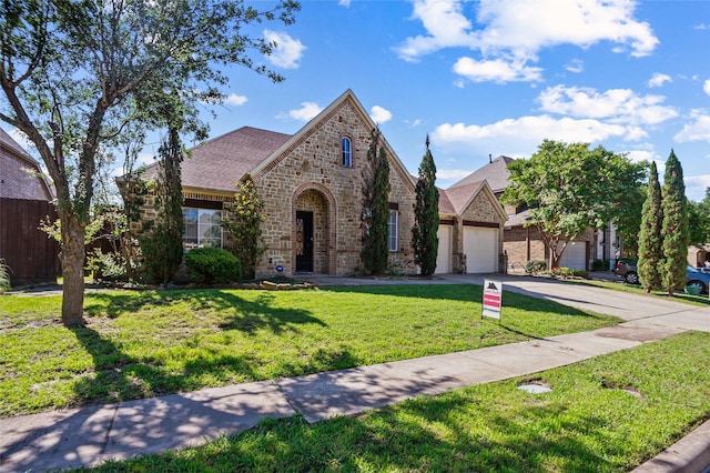 17 Wimbledon Ct, Heath, TX 75032 - view of front facade with concrete driveway, brick siding, an attached garage, a front lawn, and roof with shingles