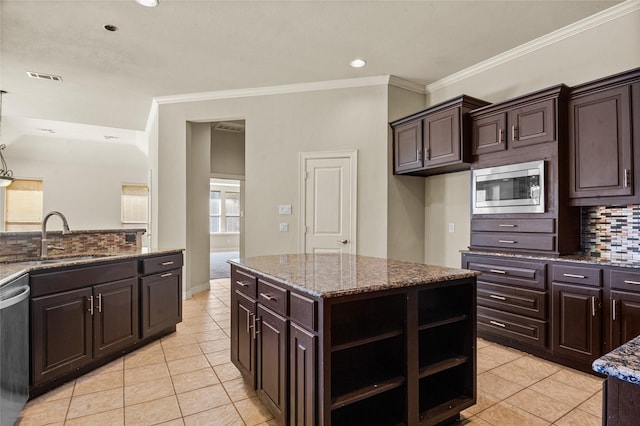 17 Wimbledon Ct, Heath, TX 75032 - kitchen featuring appliances with stainless steel finishes, a sink, light tile patterned floors, decorative backsplash, and crown molding