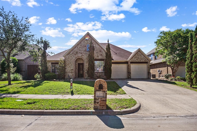 17 Wimbledon Ct, Heath, TX 75032 - view of front facade featuring an attached garage, a front yard, concrete driveway, and brick siding