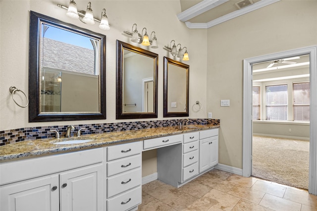 17 Wimbledon Ct, Heath, TX 75032 - full bathroom featuring double vanity, plenty of natural light, decorative backsplash, and baseboards
