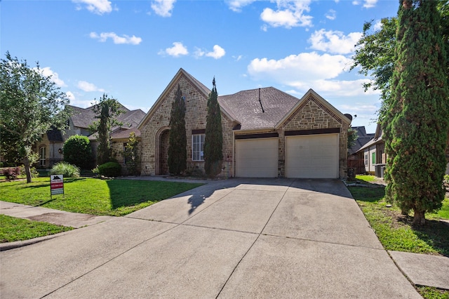 17 Wimbledon Ct, Heath, TX 75032 - french country home featuring an attached garage, driveway, a front yard, brick siding, and stone siding