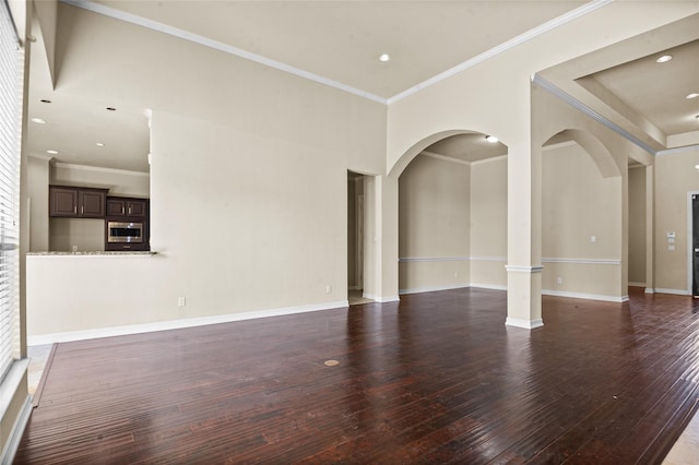 17 Wimbledon Ct, Heath, TX 75032 - unfurnished living room with arched walkways, dark wood-type flooring, crown molding, baseboards, and recessed lighting