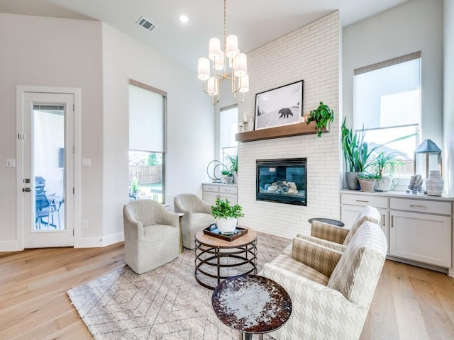 4208 Sunrise Ln, Celina, TX 75078 - living area featuring light wood-type flooring, a chandelier, a fireplace, baseboards, and recessed lighting