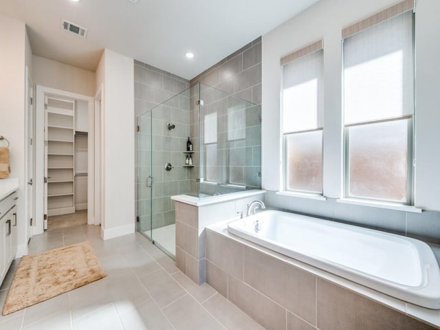4208 Sunrise Ln, Celina, TX 75078 - bathroom featuring a shower stall, tile patterned floors, a garden tub, a walk in closet, and recessed lighting