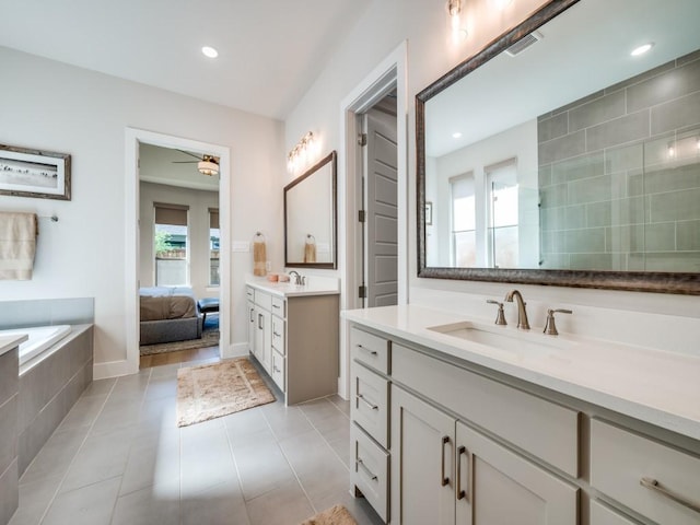 4208 Sunrise Ln, Celina, TX 75078 - bathroom featuring plenty of natural light, a ceiling fan, two vanities, tile patterned floors, and recessed lighting