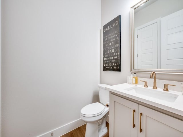 4208 Sunrise Ln, Celina, TX 75078 - half bathroom with wood finished floors, vanity, toilet, and baseboards