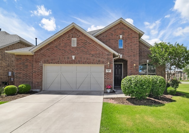 804 Countryside Way, Little Elm, TX 76227 - traditional-style house featuring brick siding, an attached garage, concrete driveway, and a front lawn