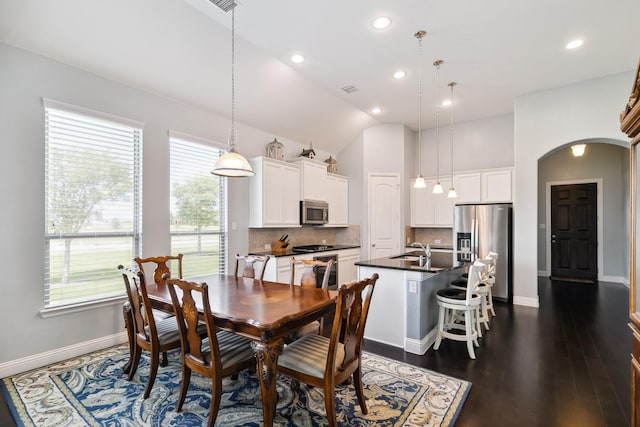 804 Countryside Way, Little Elm, TX 76227 - dining room with arched walkways, recessed lighting, baseboards, lofted ceiling, and dark wood-style flooring