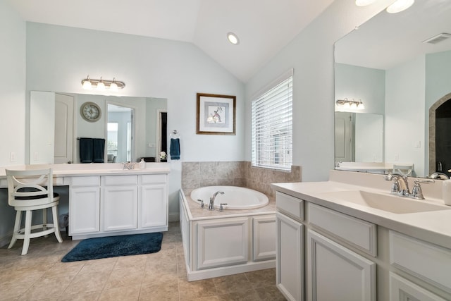 804 Countryside Way, Little Elm, TX 76227 - bathroom with vaulted ceiling, a garden tub, tile patterned flooring, and two vanities
