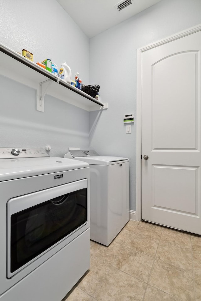 804 Countryside Way, Little Elm, TX 76227 - washroom with washer and clothes dryer and light tile patterned flooring