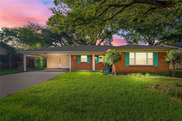 252 Brenda Dr, Shreveport, LA 71115 - ranch-style house featuring brick siding, driveway, a lawn, and an attached carport
