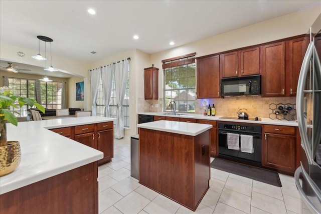 2652 Waterway Dr, Grand Prairie, TX 75054 - kitchen with black appliances, a center island, a sink, backsplash, and light countertops