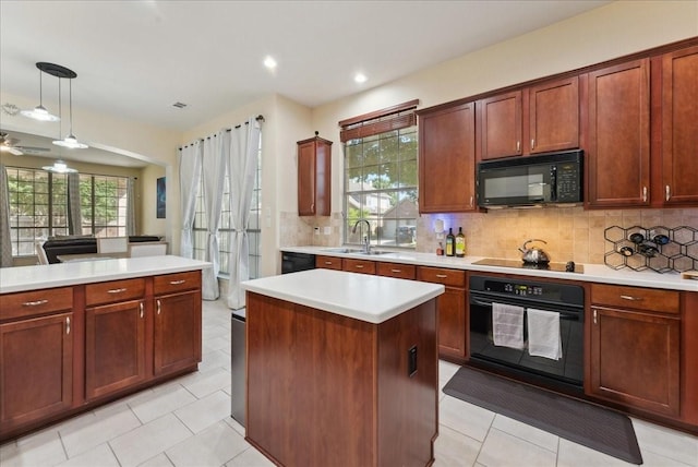 2652 Waterway Dr, Grand Prairie, TX 75054 - kitchen with black appliances, a sink, light countertops, backsplash, and hanging light fixtures