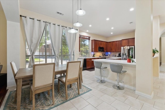 2652 Waterway Dr, Grand Prairie, TX 75054 - dining space with recessed lighting, light tile patterned floors, baseboards, and arched walkways