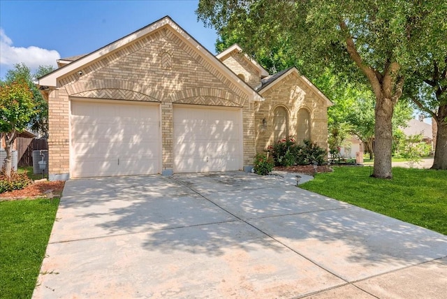 2652 Waterway Dr, Grand Prairie, TX 75054 - view of front of property featuring brick siding, a garage, driveway, and a front yard