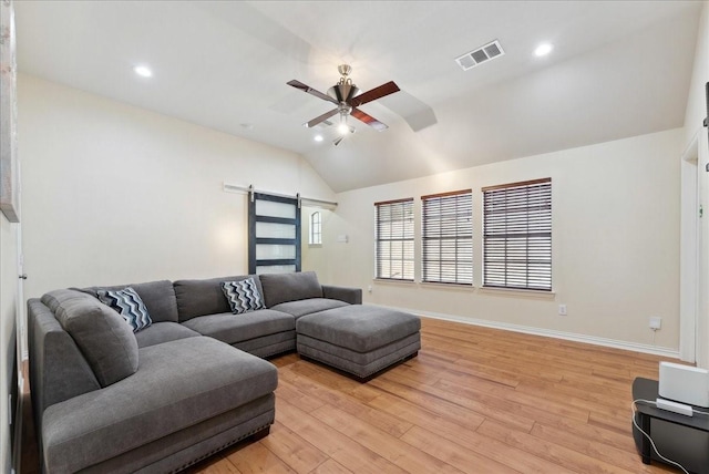 2652 Waterway Dr, Grand Prairie, TX 75054 - living room featuring a barn door, lofted ceiling, a ceiling fan, light wood-style floors, and baseboards