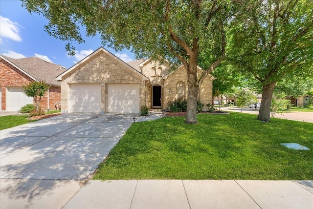 2652 Waterway Dr, Grand Prairie, TX 75054 - view of front of property with brick siding, a garage, driveway, and a front lawn