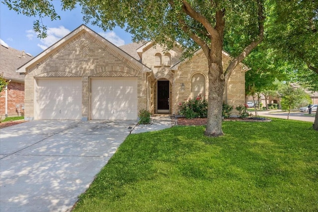 2652 Waterway Dr, Grand Prairie, TX 75054 - view of front of property with brick siding, a garage, concrete driveway, and a front lawn