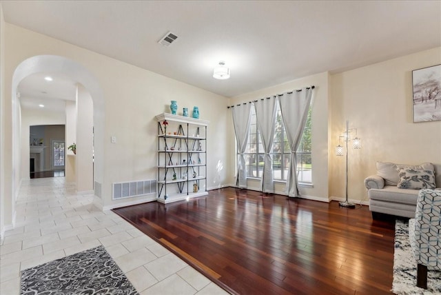 2652 Waterway Dr, Grand Prairie, TX 75054 - sitting room featuring arched walkways, baseboards, and tile patterned flooring