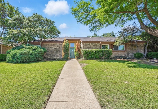 view of front of property with brick siding and a front yard