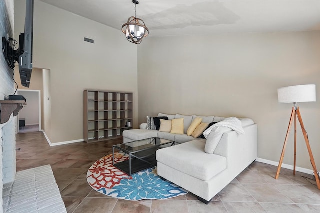 tiled living area with baseboards and a chandelier