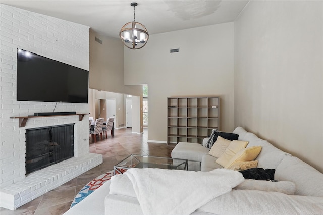 living area featuring a chandelier, a fireplace, tile patterned floors, a high ceiling, and baseboards