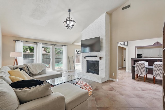 living area featuring a chandelier, high vaulted ceiling, a fireplace, and baseboards