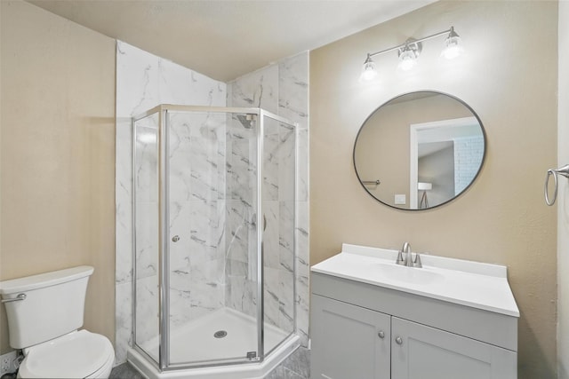full bath with a marble finish shower, toilet, and vanity