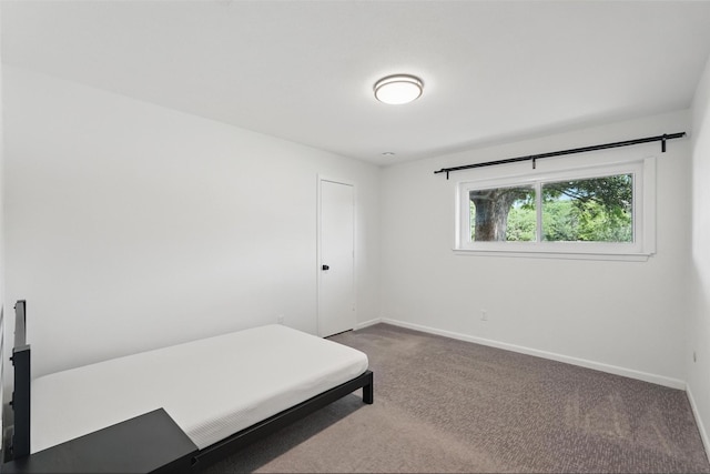 carpeted bedroom with baseboards
