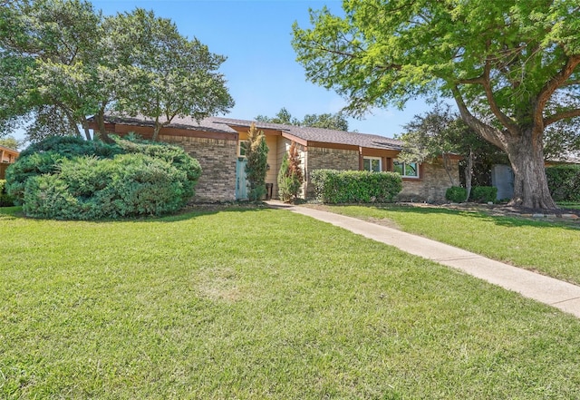 mid-century inspired home with a front lawn and brick siding