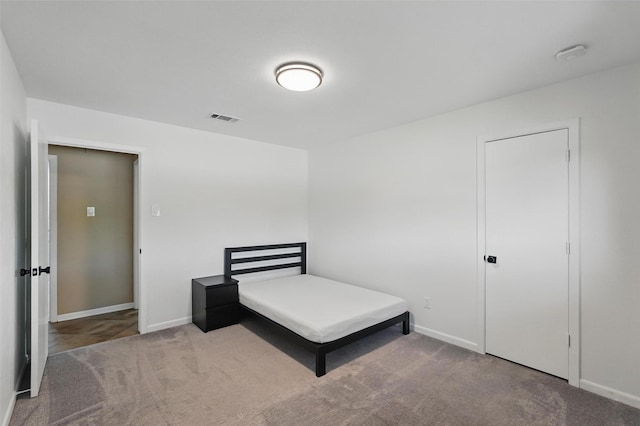 carpeted bedroom with baseboards