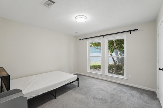 bedroom featuring carpet floors and baseboards