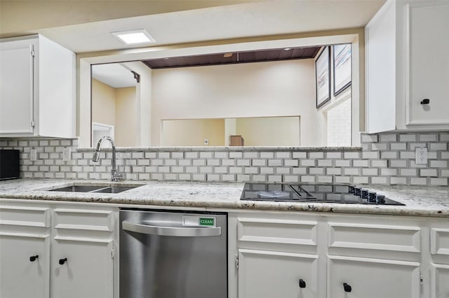 kitchen featuring stainless steel dishwasher, black electric stovetop, a sink, tasteful backsplash, and white cabinetry