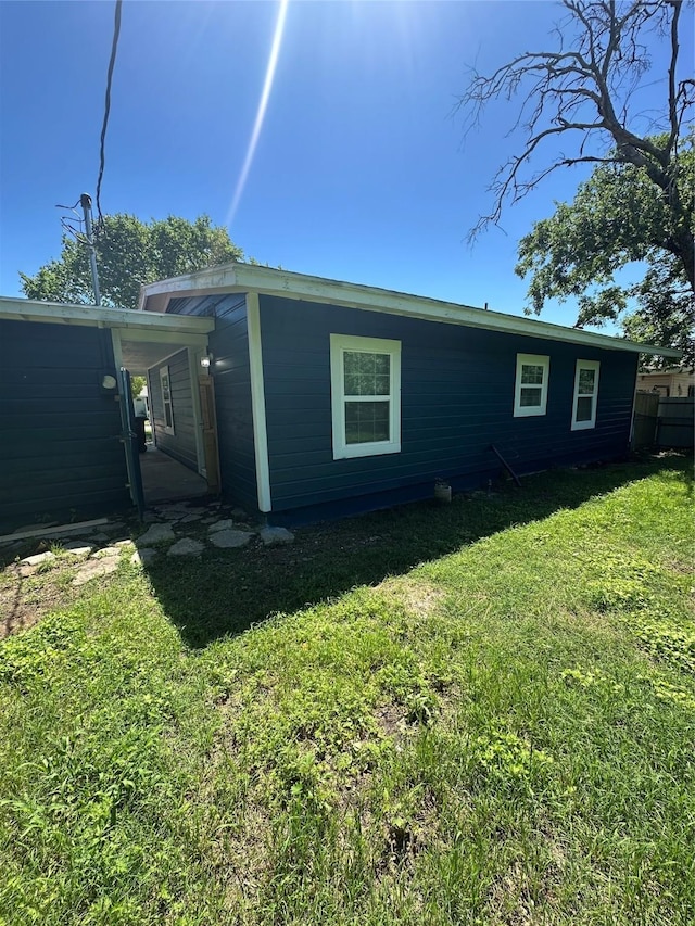 view of side of home featuring a lawn