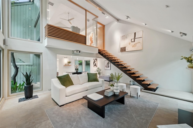 957 Easton Pl, Dallas, TX 75218 - living room with high vaulted ceiling, stairway, beamed ceiling, and tile patterned flooring