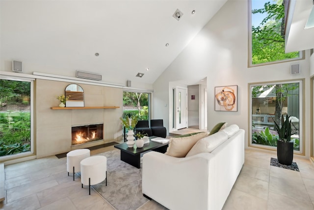 957 Easton Pl, Dallas, TX 75218 - living area with high vaulted ceiling, a glass covered fireplace, and light tile patterned floors