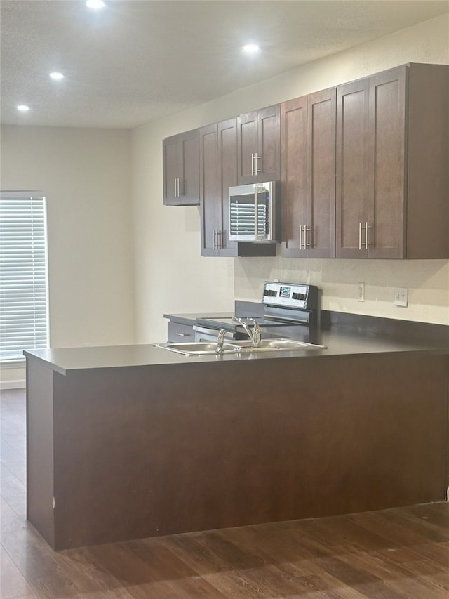 12921 Abrams Rd Unit 407, Dallas, TX 75243 - kitchen featuring electric stove, dark wood-style floors, recessed lighting, a peninsula, and dark countertops